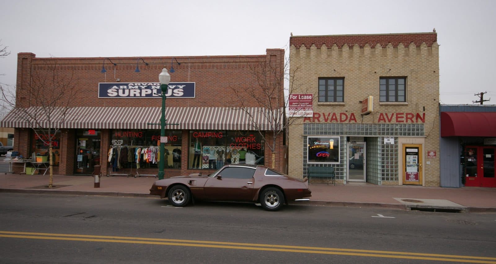 Historic brick storefronts along Olde Wadsworth Boulevard in Olde Town Arvada, including the Arvada Tavern