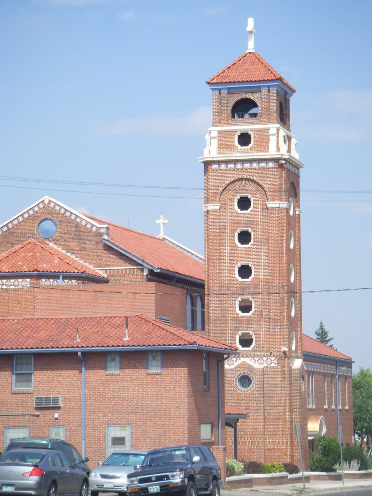The brick bell tower and facade of the historic Shrine of St. Anne in Arvada