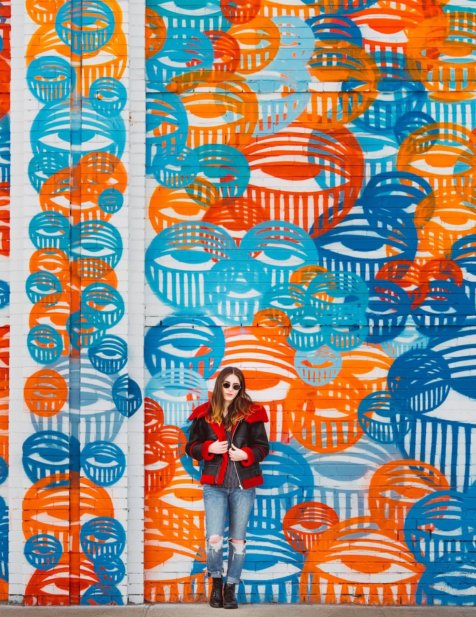 A large orange and teal geometric mural on a wall in Denver's RiNo Art District