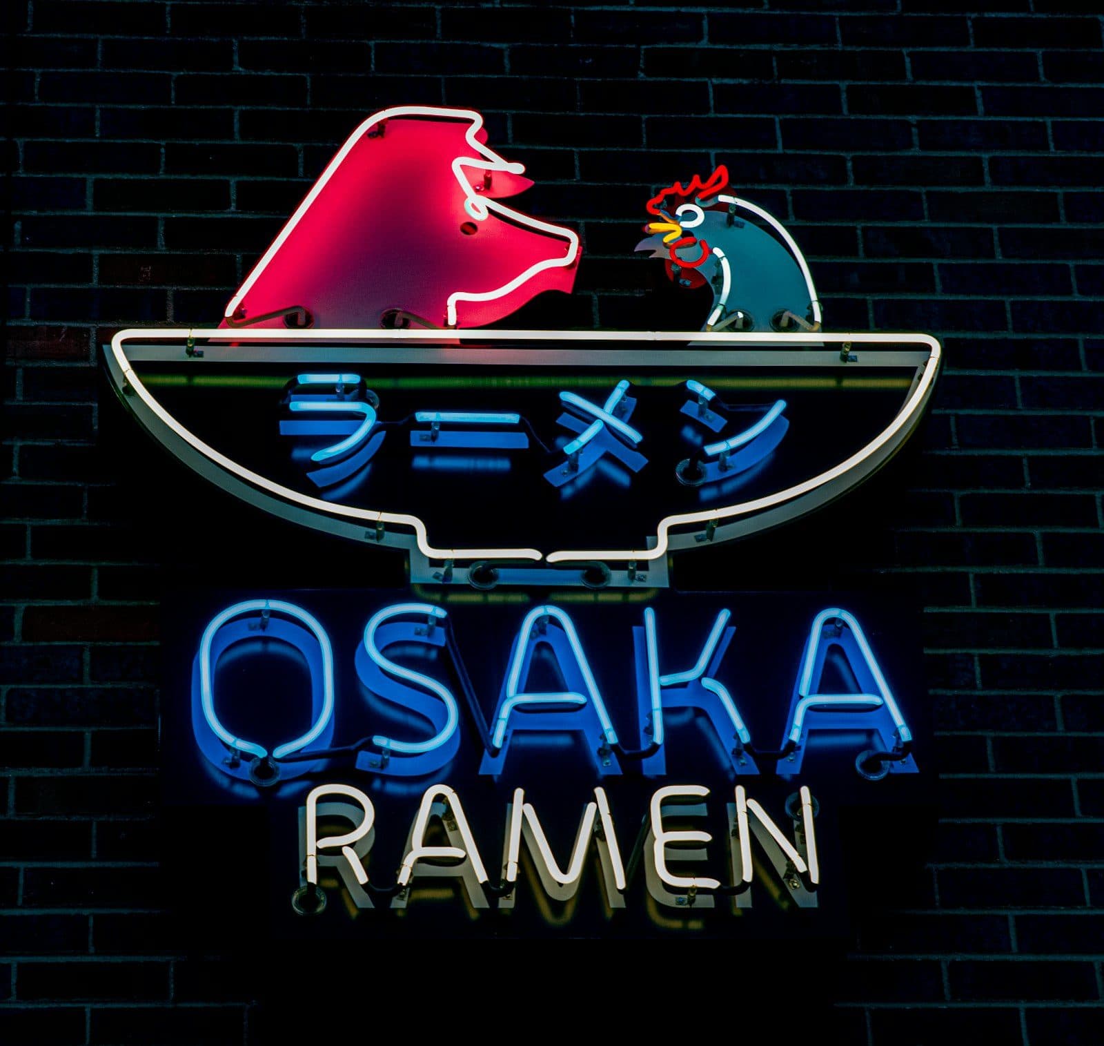 The neon Osaka Ramen sign glowing on a brick wall in RiNo, Denver