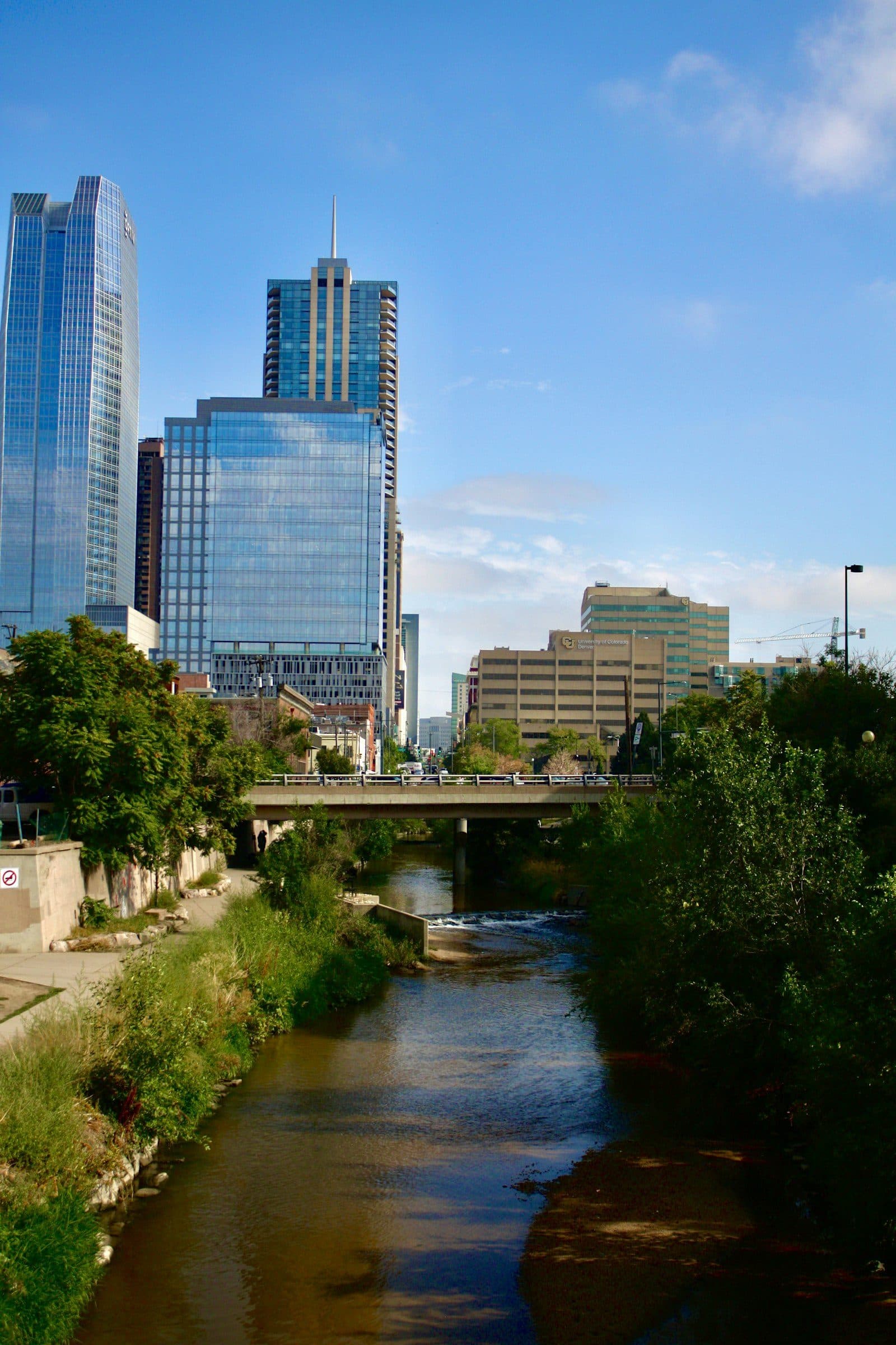 The South Platte River running past the downtown Denver skyline near RiNo